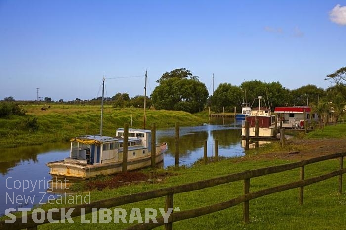 Awanui;Northland;River;Awanui River;estury;winding river;cumulus cloud;church;Norfolk pines;boats;moored boats