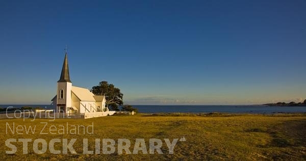 Raukokore;Anglican Church;church;bluffs;cliffs;rocky shorelines;sea fishing;Marai;Maori carving;blue sea;blue sky;golden light