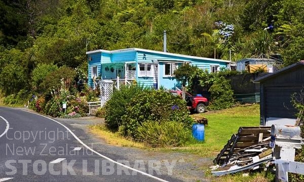 Whangaroa Harbour;Northland;bachs;holiday homes;bush;native forrest;blue sky;blue sea;Pohutakawa trees;Whangaroa Harbour -Colourful House