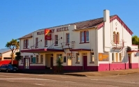 Waverley;Taranaki;Waverley_Hotel;cabbage_trees;blue_sky