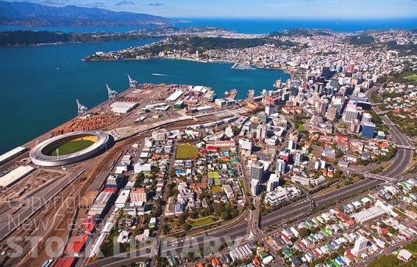 Aerial;Wellington;Beehive;parliament;down town;highrise;airport;bays;marina;docks;harbour;ferries;port;clear water;cranes;cafes;restaurants;motorway;traffic;boats;planes;aircraft;helicopters;caketin;rugby stadium;railwat station;rail lines;logs;piles of logs;logging