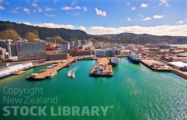 Aerial;Wellington;Beehive;parliament;down town;highrise;airport;bays;marina;docks;harbour;ferries;port;clear water;cranes;cafes;restaurants;motorway;traffic;boats;planes;aircraft;helicopters;caketin;rugby stadium;railwat station;rail lines;logs;piles of logs;logging