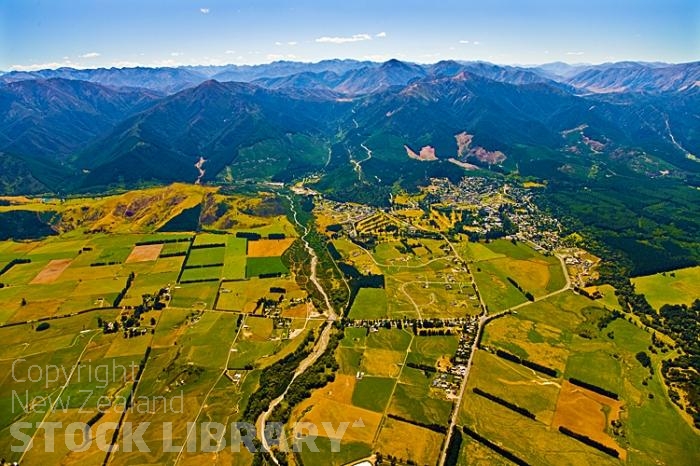 Aerial;green fields;paddocks;brown hills;hills;mountains;blue sky;Hanmer Range;Amuri Range;Hanmer Plain;Waiau River;Hanmer River;bush;native forrest;paddocks;green fields