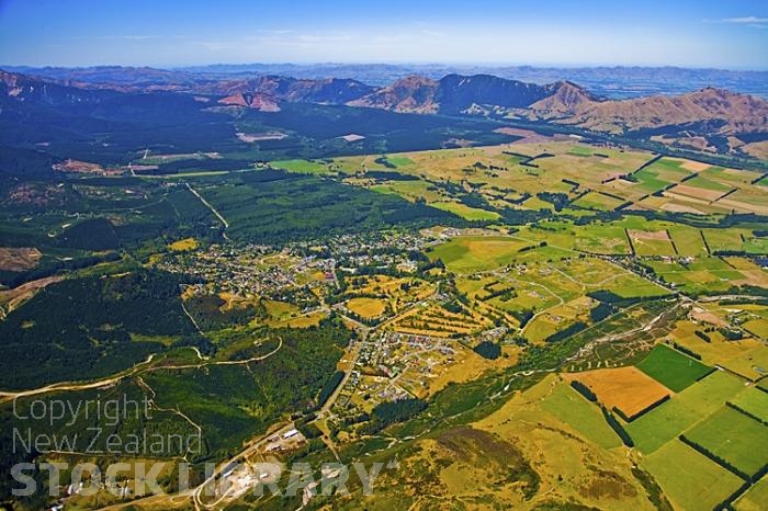 Aerial;Hanmer Springs;green fields;paddocks;brown hills;hills;mountains;blue sky;Hanmer Range;Amuri Range;Hanmer Plain;Waiau River;Hanmer River;bush;native forrest;airfield