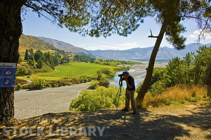 Hanmer Springs;green fields;paddocks;brown hills;hills;mountains;blue sky;Hanmer Range;Amuri Range;Hanmer Plain;Waiau River;Hanmer River;bush;native forrest;Photographer at Work;Photographer;Work