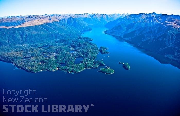 Aerial;Lake Te Anau;Fiordland;mountains;hills;rivers;Road;State Highway 94;bush;native forrest;Te Anau;green fields;green paddocks;lakes;blue sky;South Fiord