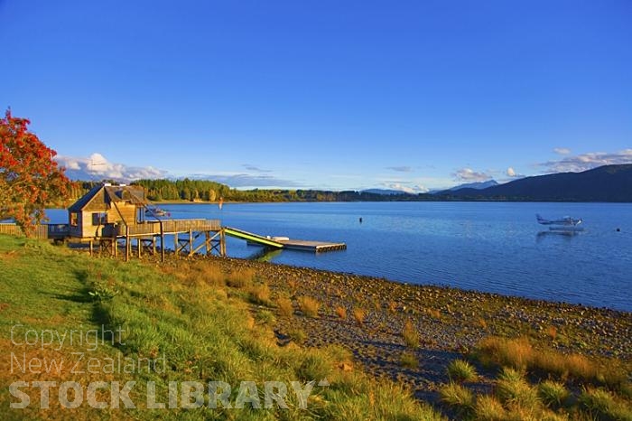 Lake Te Anau;Fiordland;mountains;hills;rivers;Road;State Highway 94;bush;native forrest;Te Anau;green fields;green paddocks;lakes;blue sky;flying operations base;flying;operations;base;floatplane;jetty;pier