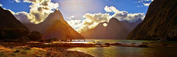 Milford Sound;Fiordland;mountains;hills;rivers;Road;State Highway 94;bush;native forrest;green fields;green paddocks;lakes;blue sky;Mitre Peak;pebble beach;back lit