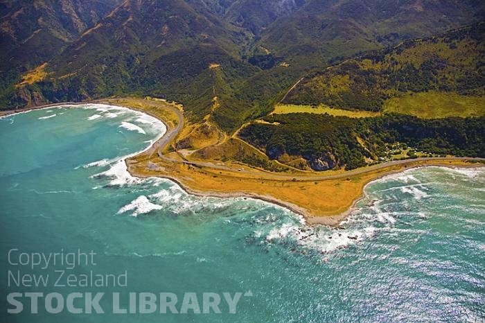 Aerial;Kaikoura Coast;Kaikoura;bush;native forest;seaward Kaikoura Range;green fields;paddocks;brown hills;hills;mountains;rivers;ocean;pacific ocean;Okiwi Bay;rocky shoreline;road;coast road;rail;rail line