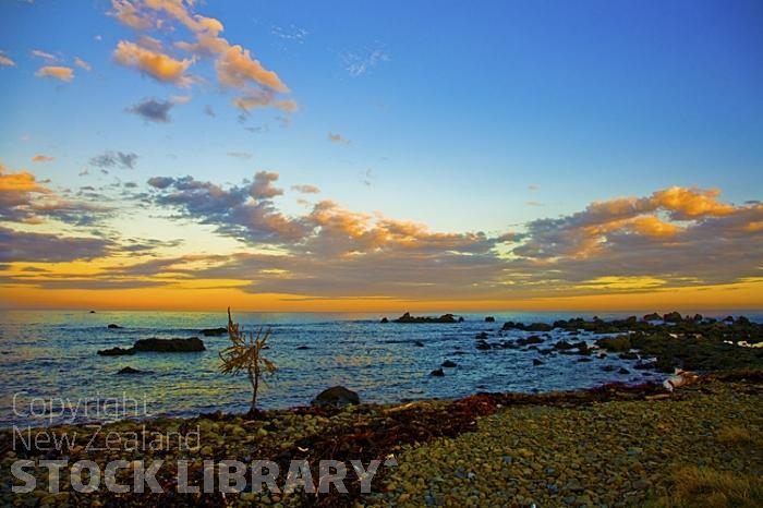 Kaikoura Coast;Kaikoura;bush;native forest;seaward Kaikoura Range;green fields;paddocks;brown hills;hills;mountains;rivers;ocean;pacific ocean;coast road;road;rail line;rocky shoreline;sea;sea wall;Kaikoura Coast;Paparoa Pt;Evening